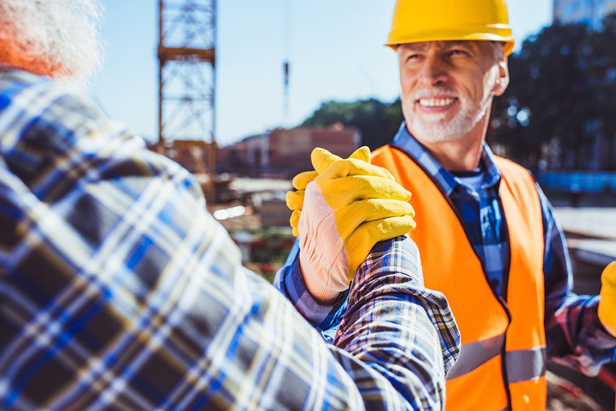 Business Insurance - View of Mature Contractor Shaking Hands with Client